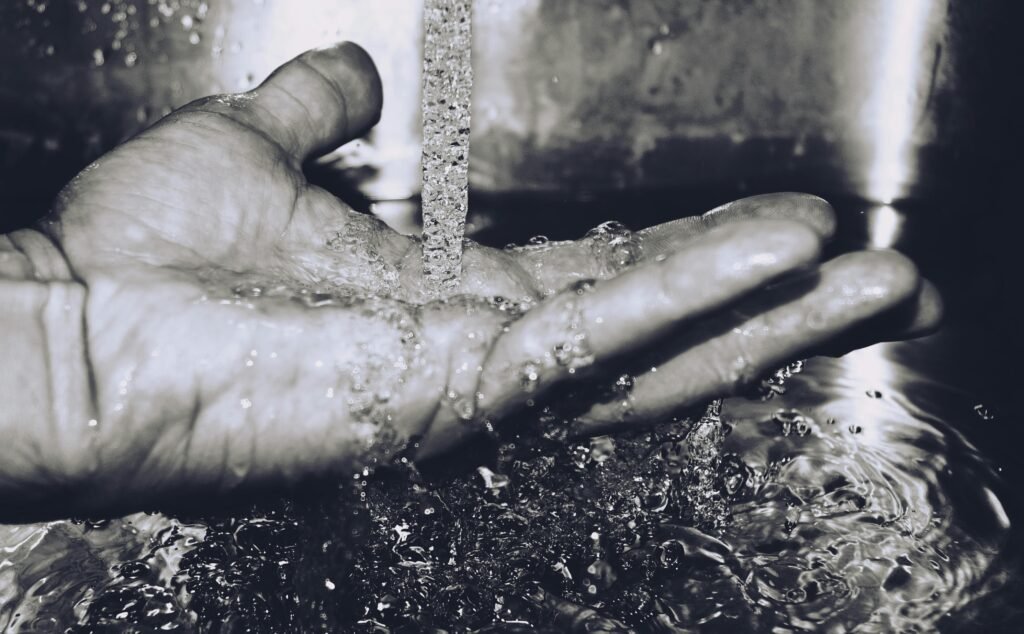 A hand catches running water